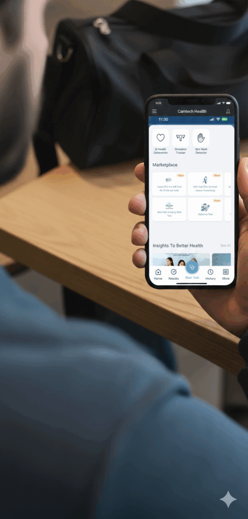 Close-up of a user holding a smartphone displaying the Camtech Health app interface, featuring digital health tools for HPV screening, AI health tracking, and diagnostic tests.
