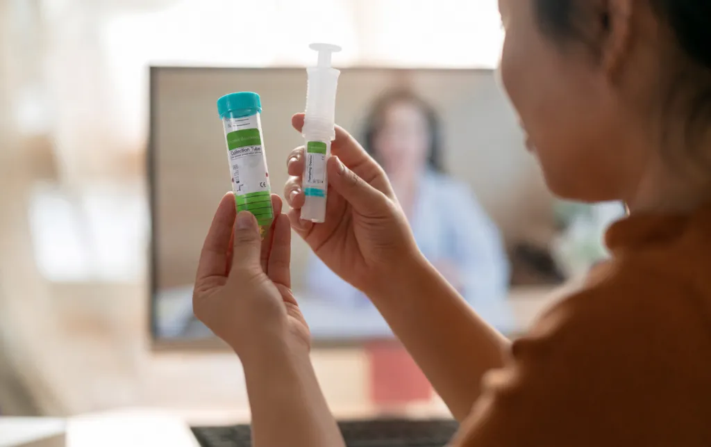 Person using a Camtech home screening kit for colon cancer.