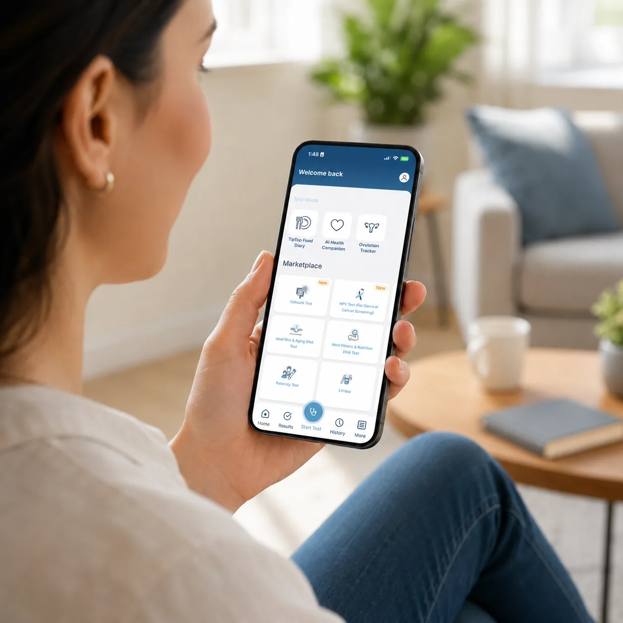 Adult viewing the Camtech Health App on a smartphone in a bright modern living room